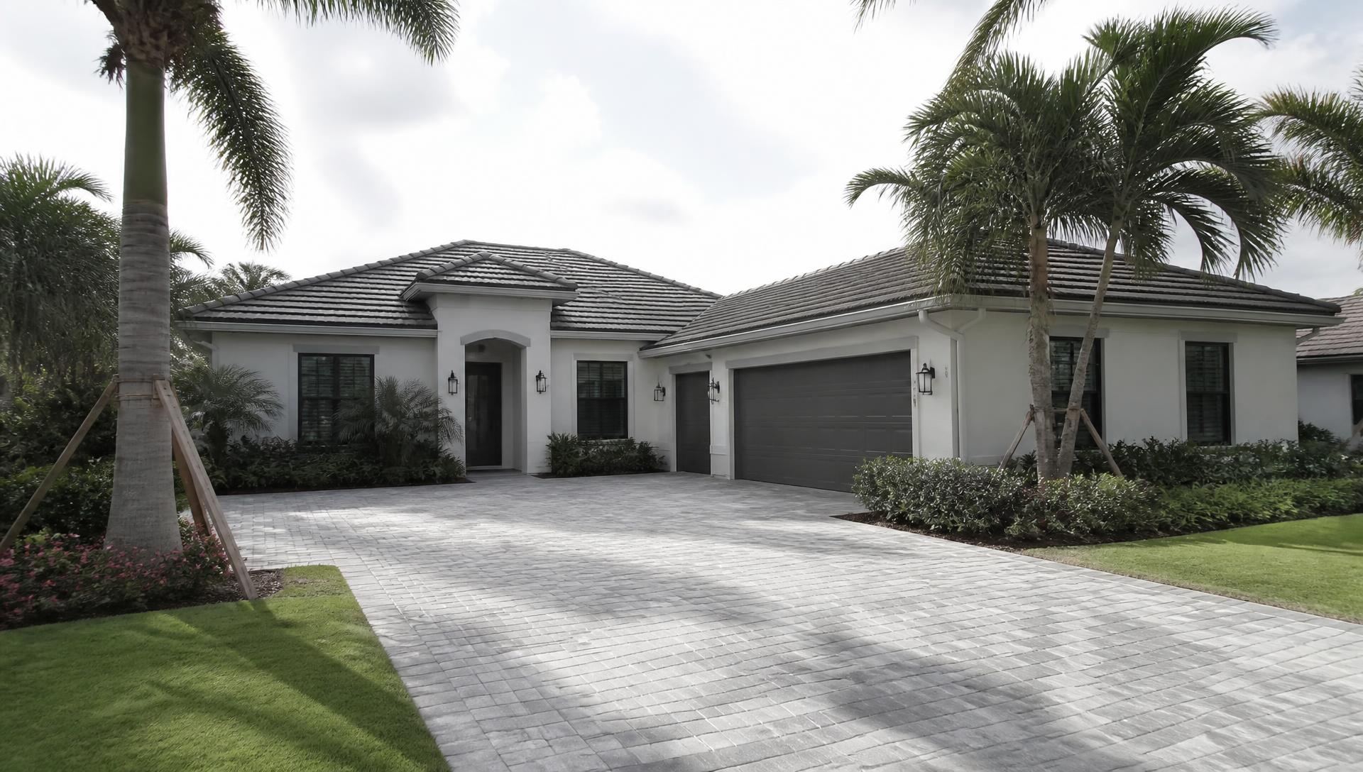 Modern Florida home with a tile roof and palm trees in the front yard